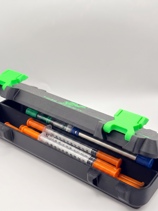Bkack and Green 3D printed syringe storage case loaded with syringes and pens — The Protector by Vial Buddy